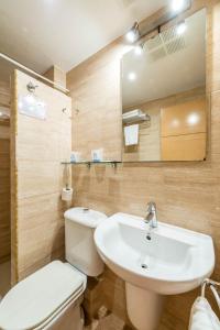 a bathroom with a white toilet and a sink at Hostal Residencia Europa Punico in Ibiza Town