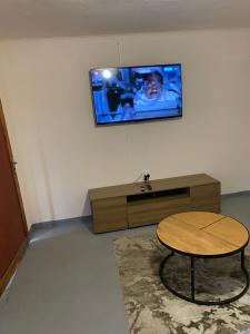 a room with a table and a tv on a wall at Zalu Lodge in Lusikisiki +18 photos