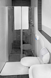 e bagno con doccia, servizi igienici e lavandino. di Hotel 37 a Landshut