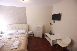 a bedroom with a bed and a desk and a television at Отель Гора in Kharkiv