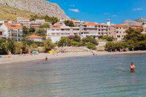 a group of people in the water at a beach at Apartments Sea View in Omiš