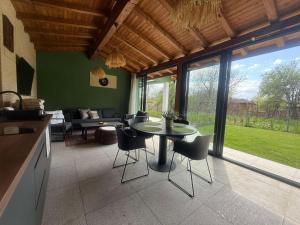eine Küche und ein Wohnzimmer mit Tisch und Stühlen in der Unterkunft Villa Green House in Tscherweni Breg