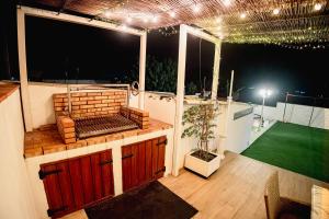 an outdoor deck with a grill and a tennis court at La Mediterranea in Palafolls