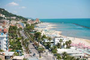 a view of a beach with a crowd of people at RESIDENZA GIULIA e LIDIA - PERLA DELL'ADRIATICO in Grottammare