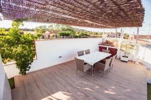 a patio with a table and chairs on a balcony at La Mediterranea in Palafolls
