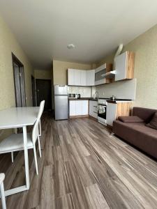 a kitchen and living room with a table and a couch at Республіка 145 in Kyiv +9 photos