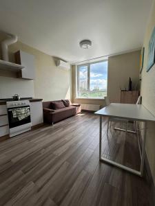 a living room with a table and a couch at Республіка 145 in Kyiv