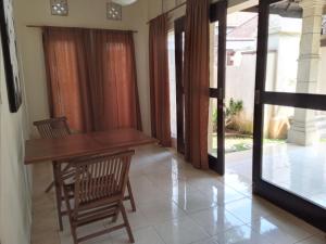 a dining room with a table and two chairs at The Paradise Bali in Badung