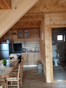 a kitchen with a table and a stove top oven at Vila Planinski san 1 in Zaovine +16 photos