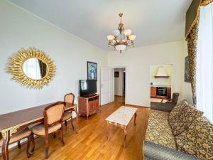 a living room with a table and a couch at Boutique Hotel Romanza in Mariánské Lázně
