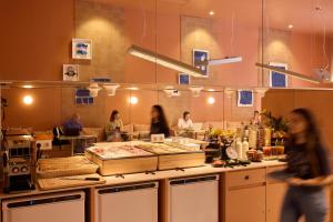 a group of people working in a restaurant kitchen at Latroupe Poblenou Beach in Barcelona