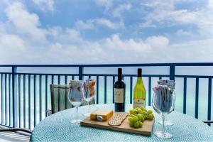 a table with two bottles of wine and wine glasses at Romantic Beachfront Sunsets in Panama City Beach