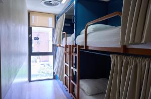 two bunk beds in a room with a window at Latroupe Poblenou Beach in Barcelona
