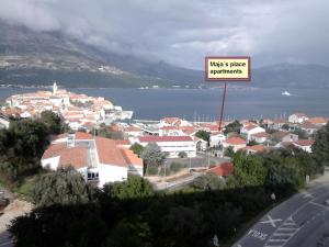 a city with a sign that reads musics phase experiments at Maja's Place Apartments in Korčula