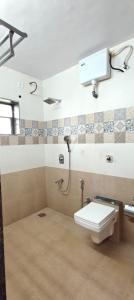 a bathroom with a toilet and a shower at The Elite Villa 2 Bhk in Panchgani +6 photos