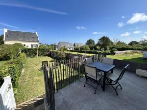 Una mesa y sillas en un patio. en 767 - Maison dans un lieu calme à 850m de la plage, en Erquy