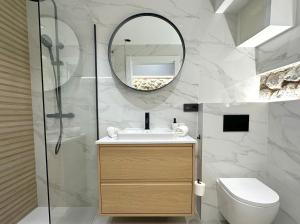 a bathroom with a sink and a mirror at House with a patio in the center in Laredo +24 photos