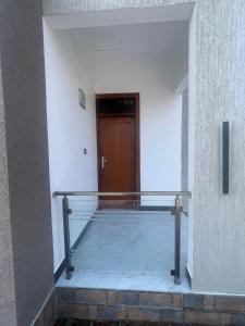 a hallway with a metal railing in a building at La Million Palace - Dodoma in Dodoma