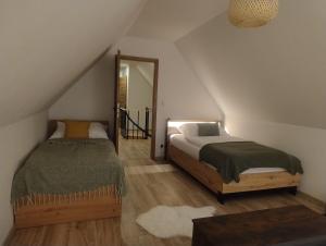 a bedroom with a bed and a mirror at Chalúpka pod Hradom Lednica 