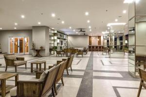 a lobby with chairs and tables in a building at Condo Unit at La Verti Residences in Manila