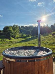 a hot tub with the sun in a field at Domki pod Bukowym Lasem in Wańkowa +194 photos