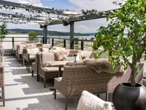 a row of tables and chairs on a patio at Quality Hotel Strand Gjøvik in Gjøvik