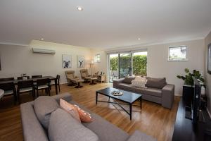 a living room with a couch and a table at Coastal Elegance Relaxed Stay in Broadwater in Broadwater