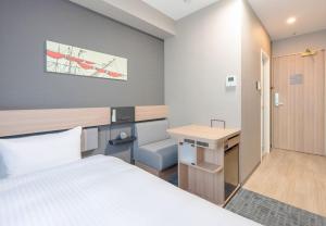Postel nebo postele na pokoji v ubytování Washington R&B Hotel Shin Yokohama Ekimae