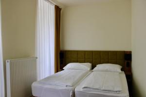 Postel nebo postele na pokoji v ubytování City Inn 24H Self Check-In by H&H Hotels