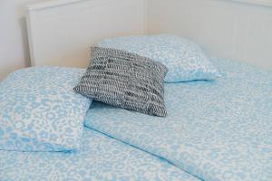 an unmade bed with a pillow on top of it at Flex SelfCheckIns 99 - 2 Bedrooms - Parking - Loggia in Velika Mlaka