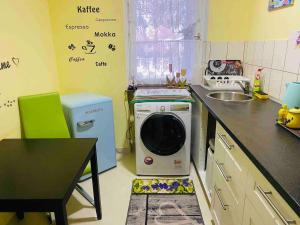 a kitchen with a washing machine and a sink at Fun Franz for 6 Persons in Baldham