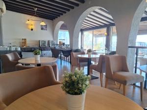 a dining room with tables and chairs and a restaurant at Hôtel Bel Azur in Six-Fours-les-Plages