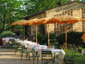a group of tables and chairs with umbrellas at Il Rosolaccio in San Gimignano