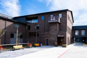 a red brick building with a sign on it at Equicor in Lviv