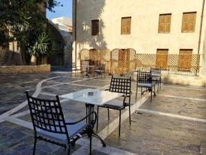 a table and chairs in front of a building at Fabrizio del Carretto in Rhodes Town