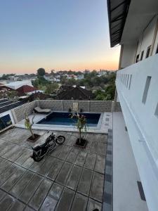 a motorcycle parked on the roof of a house at Pradnya Homestay Ungasan - Room near Uluwatu in Uluwatu +18 photos