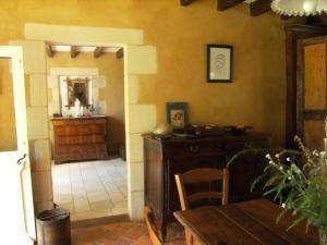 a dining room with a table and a mirror at La Maison d'hôtes du Bec d'Allier in Marzy