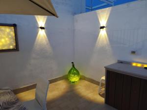 a room with a vase and lights on the wall at Casina Viestana in Vieste +53 photos