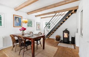 a dining room with a table and a fireplace at Amazing Home In Aabenraa With Wifi in Aabenraa