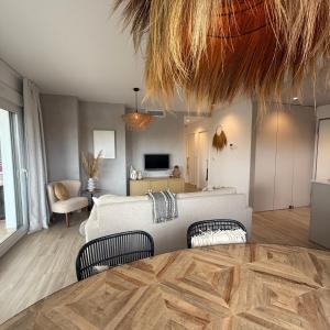 a bedroom with a bed and a living room at Casa Paloma Blanca in Orihuela