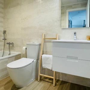 a bathroom with a toilet and a sink and a mirror at Casa Paloma Blanca in Orihuela +36 photos