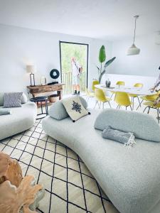 a living room with a couch and a table and chairs at Blue Hill House Ibiza 360-degree Exclusiveness in San Jose +31 photos