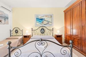 a bedroom with two beds and wooden cabinets at Casa Vacanze Antica Dimora in Scano Montiferro