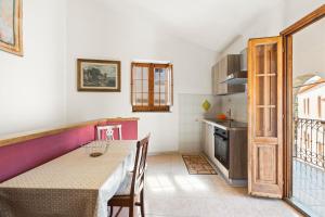 a kitchen with a table and a dining room at Casa Vacanze Antica Dimora in Scano Montiferro