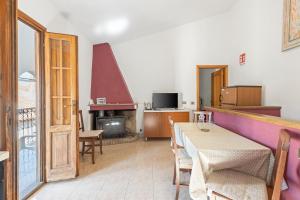 a dining room with a table and a fireplace at Casa Vacanze Antica Dimora in Scano Montiferro