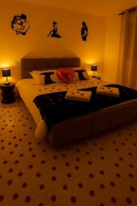 a bedroom with a large bed with two lamps at Love Room Royan in Royan