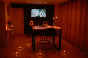 a dining room with a table with candles and lights at Love Room Royan in Royan