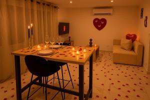 a table with candles and wine glasses in a living room at Love Room Royan in Royan