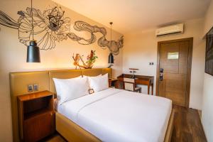 a hotel room with a bed and a door at The Henry Hotel Roost Bacolod in Bacolod