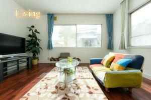 a living room with a couch and a glass table at Sapporo - house / Vacation STAY 697 in Sapporo